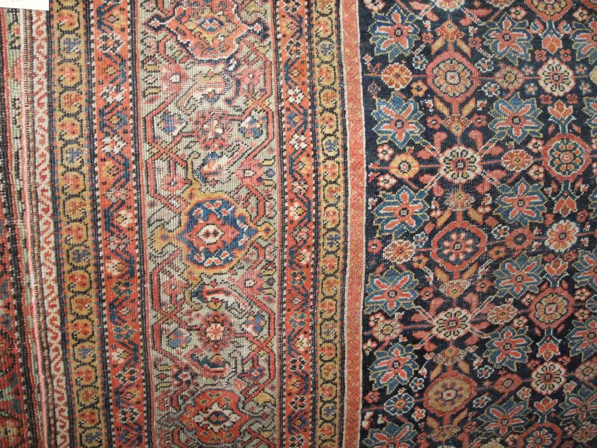 Appraisal: An eastern wool carpet with blue ground field multi-floral detail