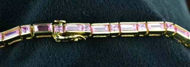 Appraisal: TENNIS BRACELET WITH PINK STONESConsisting of pink CZ bracelet with