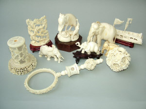 Appraisal: A collection of Chinese ivory carvings comprising a puzzle ball