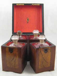 Appraisal: A four bottle decanter set in a mahogany and walnut