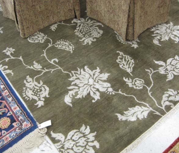 Appraisal: HAND KNOTTED ORIENTAL CARPET having ivory floral decoration on borderless