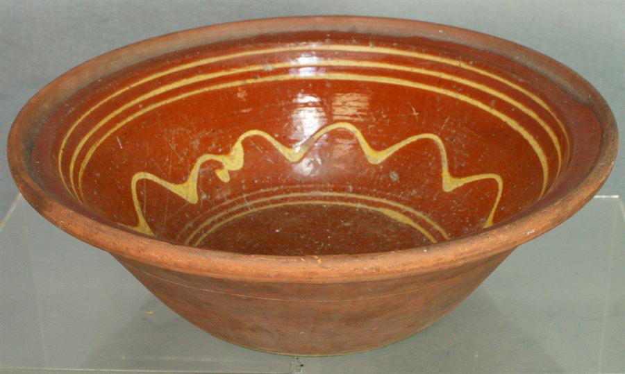 Appraisal: Redware mixing bowl with line and squiggle slip decoration unglazed