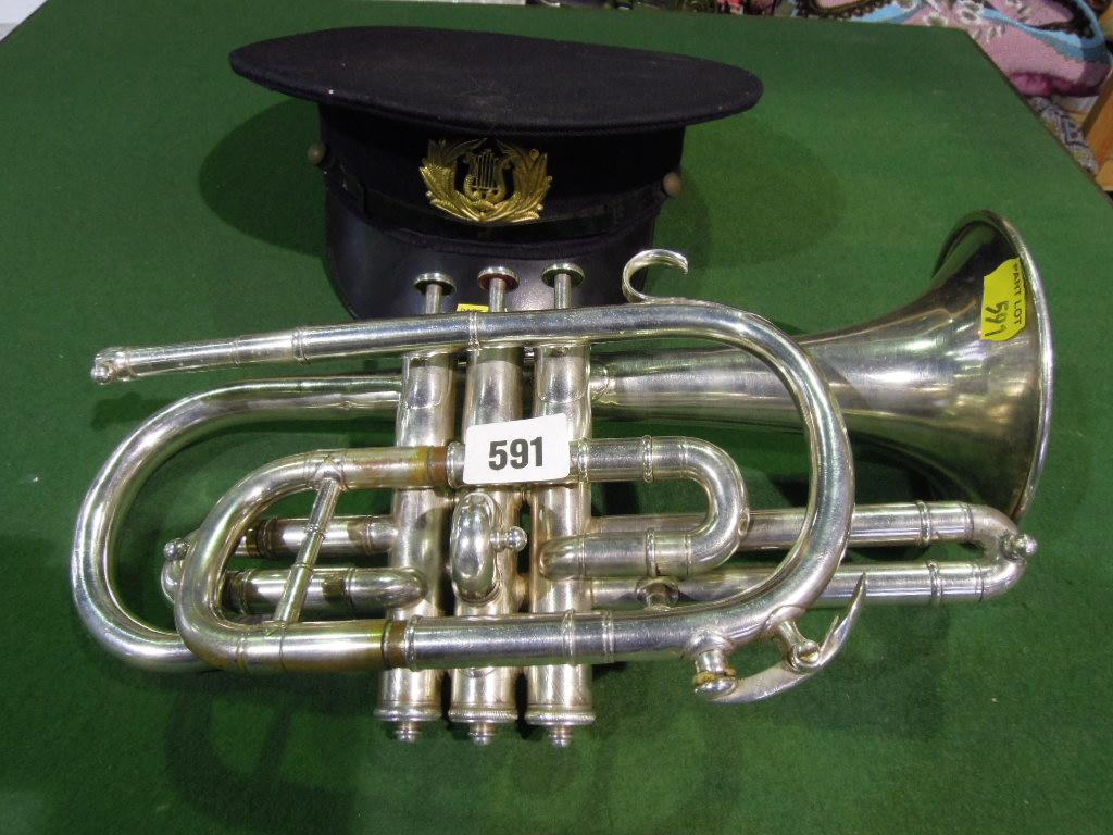 Appraisal: A white metal cased cornet together with a bandsmen's cap