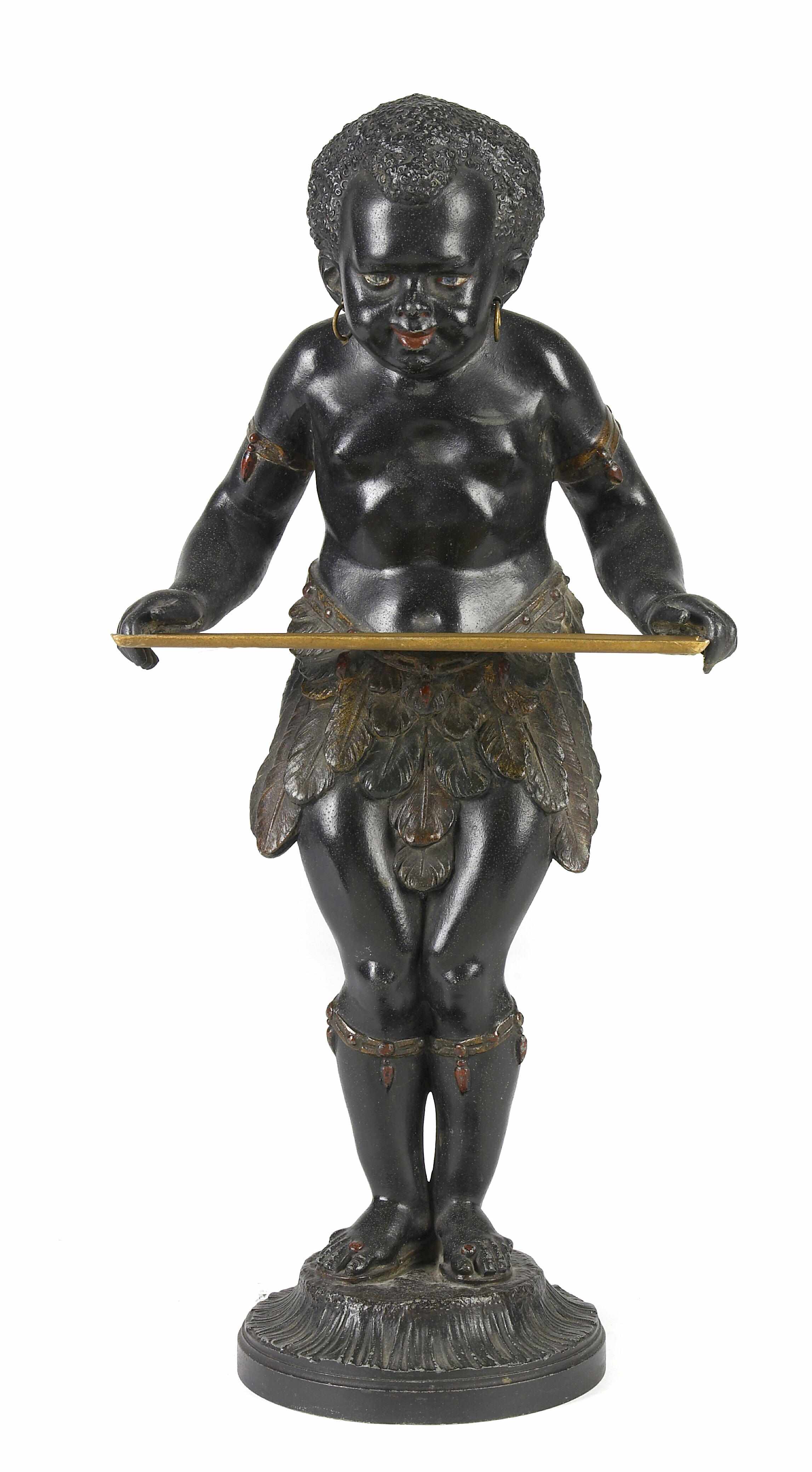 Appraisal: A patinated metal figure of a standing blackamoor holding a