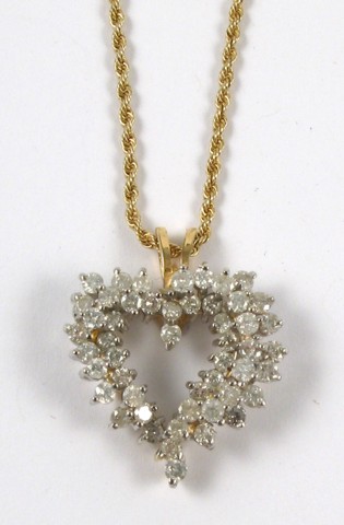 Appraisal: DIAMOND AND YELLOW GOLD PENDANT NECKLACE The heart shaped pendant