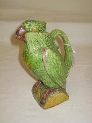 Appraisal: A MAJOLICA JUG modelled as a green parrot perched on