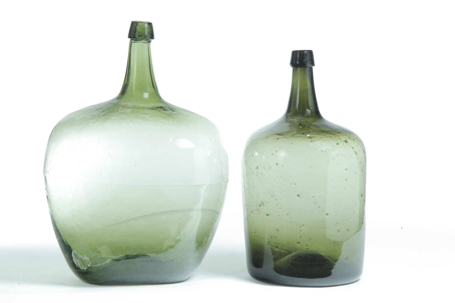 Appraisal: TWO AMERICAN BLOWN GLASS DEMIJOHNS Nineteenth century Olive green glass