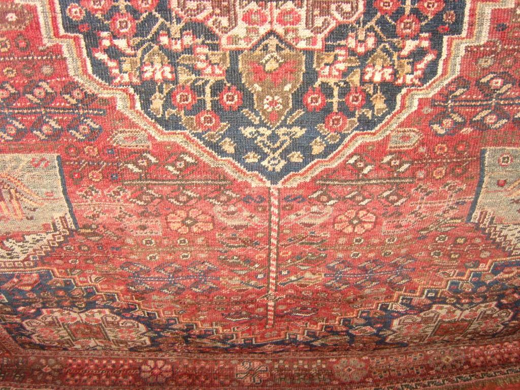 Appraisal: A red ground eastern wool rug with stylised floral and