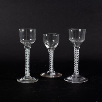 Appraisal: Three th Century cordial glasses with double opaque twist stem