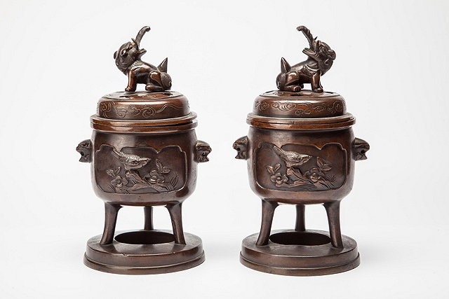 Appraisal: A PAIR OF JAPANESE COVERED CENSERS each with stylised elephant