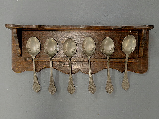 Appraisal: Oak hanging spoon rack with six pewter spoons h x