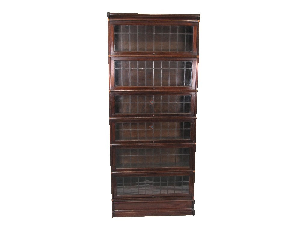 Appraisal: A mahogany six section stacking bookcase with leaded glass doors