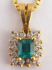 Appraisal: A yellow metal tests carat gold emerald and diamond pendant