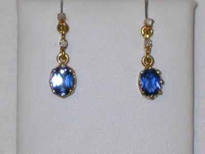 Appraisal: A PAIR OF OVAL SAPPHIRE DROP EARRINGS suspended via two