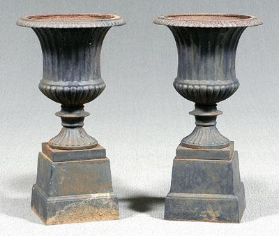 Appraisal: Pair cast iron garden urns in two parts each fluted