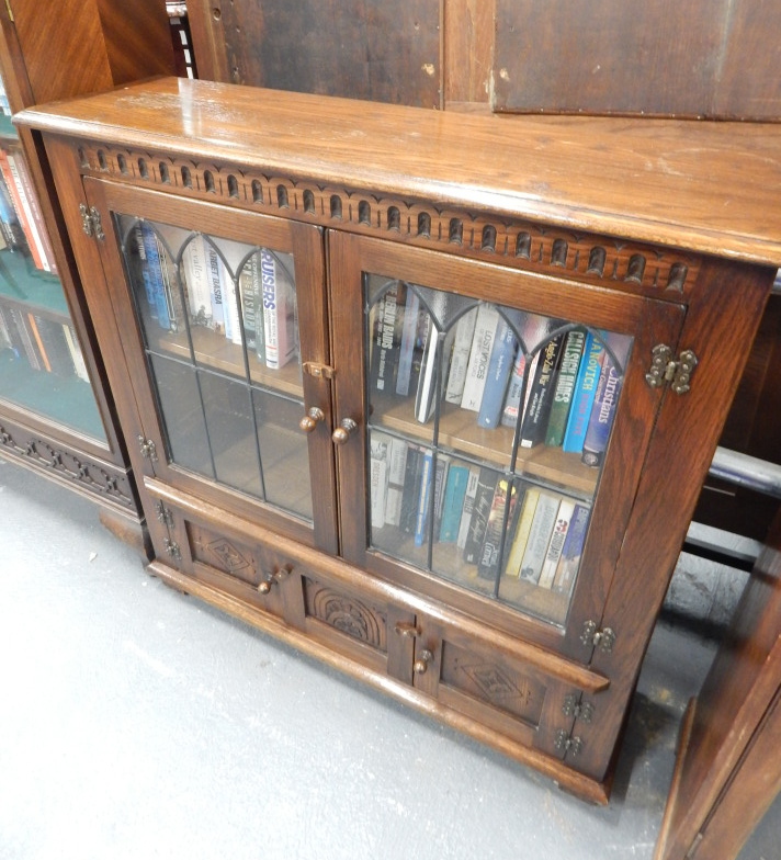 Appraisal: A reproduction oak bookcase with two leaded glazed doors above