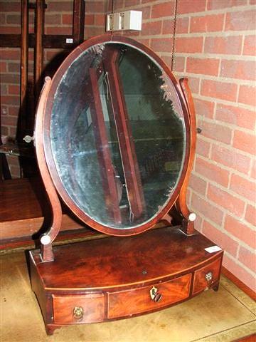 Appraisal: A GEORGE III BOW FRONTED MAHOGANY BOX TOILET MIRROR with