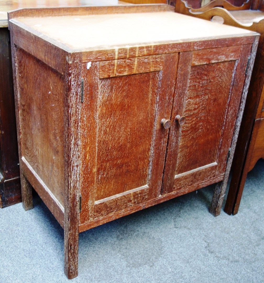 Appraisal: An early th century limed oak two door side cupboard