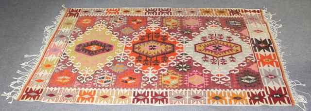 Appraisal: A Kilim rug with medallions on a red ground cm