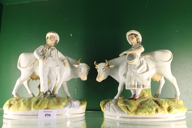 Appraisal: A PAIR OF VICTORIAN STAFFORDSHIRE POTTERY MODELS OF COWS each