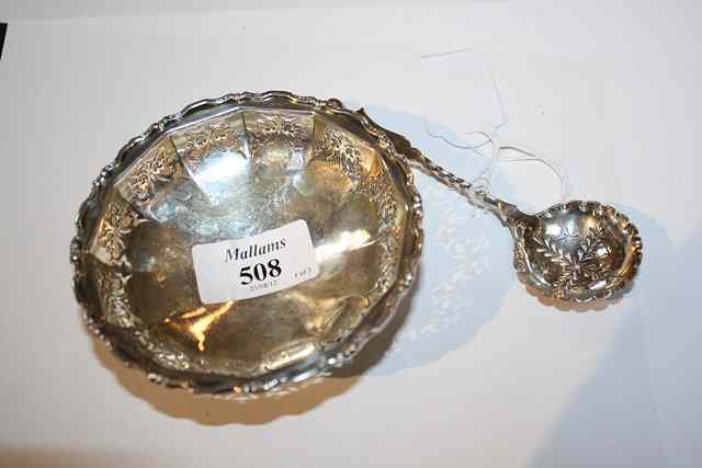 Appraisal: A SILVER BON BON DISH with pierced panelled sides scrolled