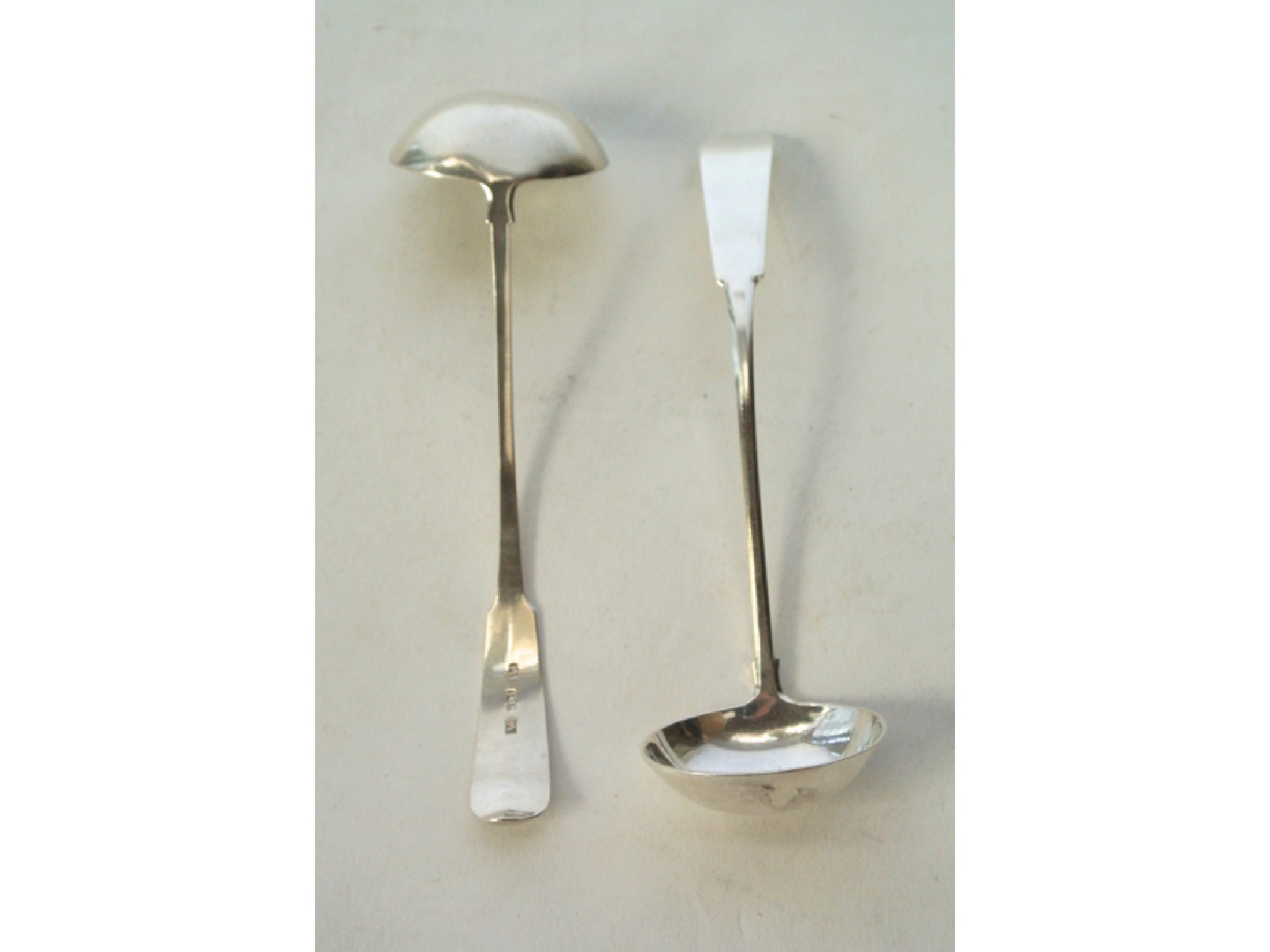 Appraisal: A pair of Scottish Provincial silver sauce ladles Peter Ross