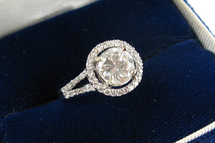 Appraisal: DIAMOND AND EIGHTEEN KARAT WHITE GOLD RING centering a round