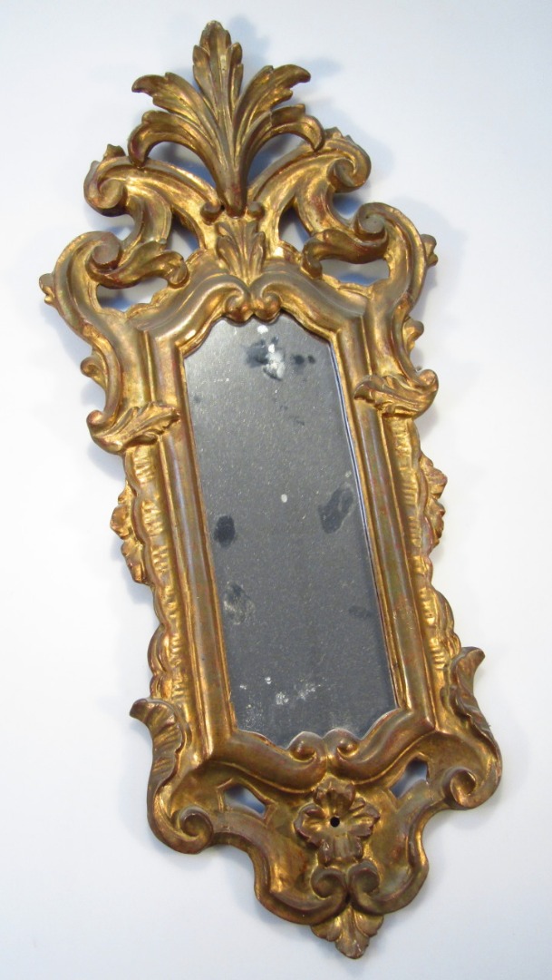 Appraisal: A rococo design gilt wood mirror with slender glass in