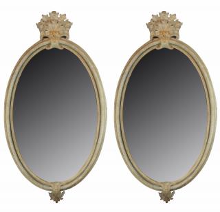 Appraisal: A pair of Italian Rococo oval mirrors with large carved