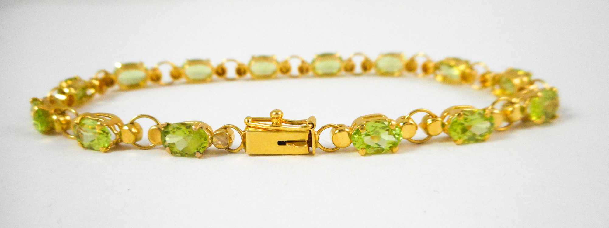 Appraisal: PERIDOT AND TEN KARAT YELLOW GOLD BRACELET measuring inches in