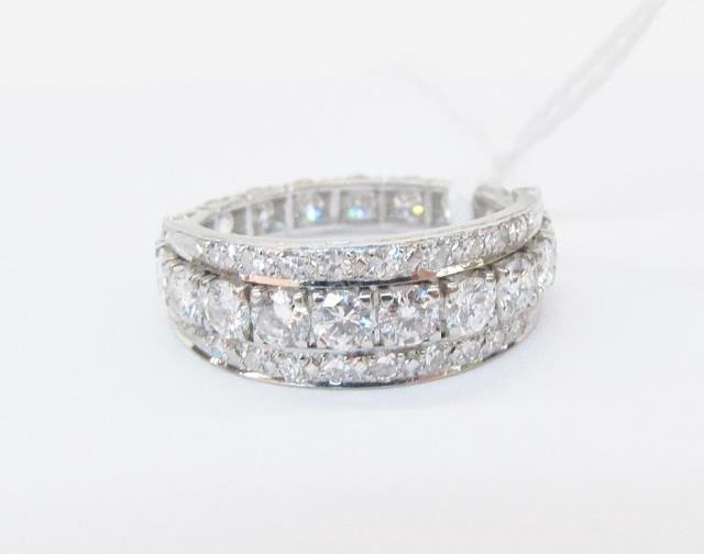 Appraisal: Platinum flip style band ring with approximately thirty-eight round diamonds