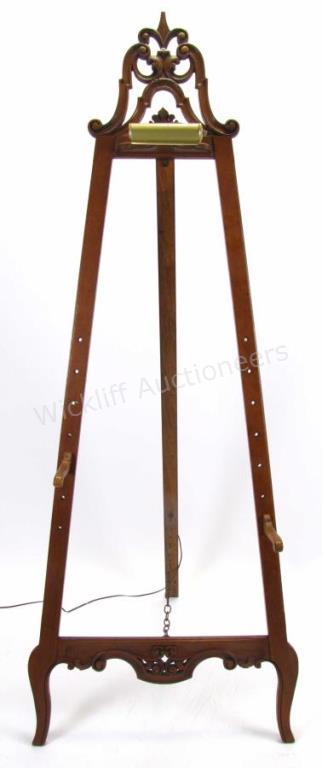 Appraisal: An antique carved fruitwood floor easel carved top decoration with