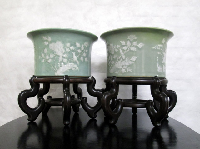 Appraisal: A PAIR OF CHINESE LUNG CHUAN CELADON JARDINIERES ON WOOD