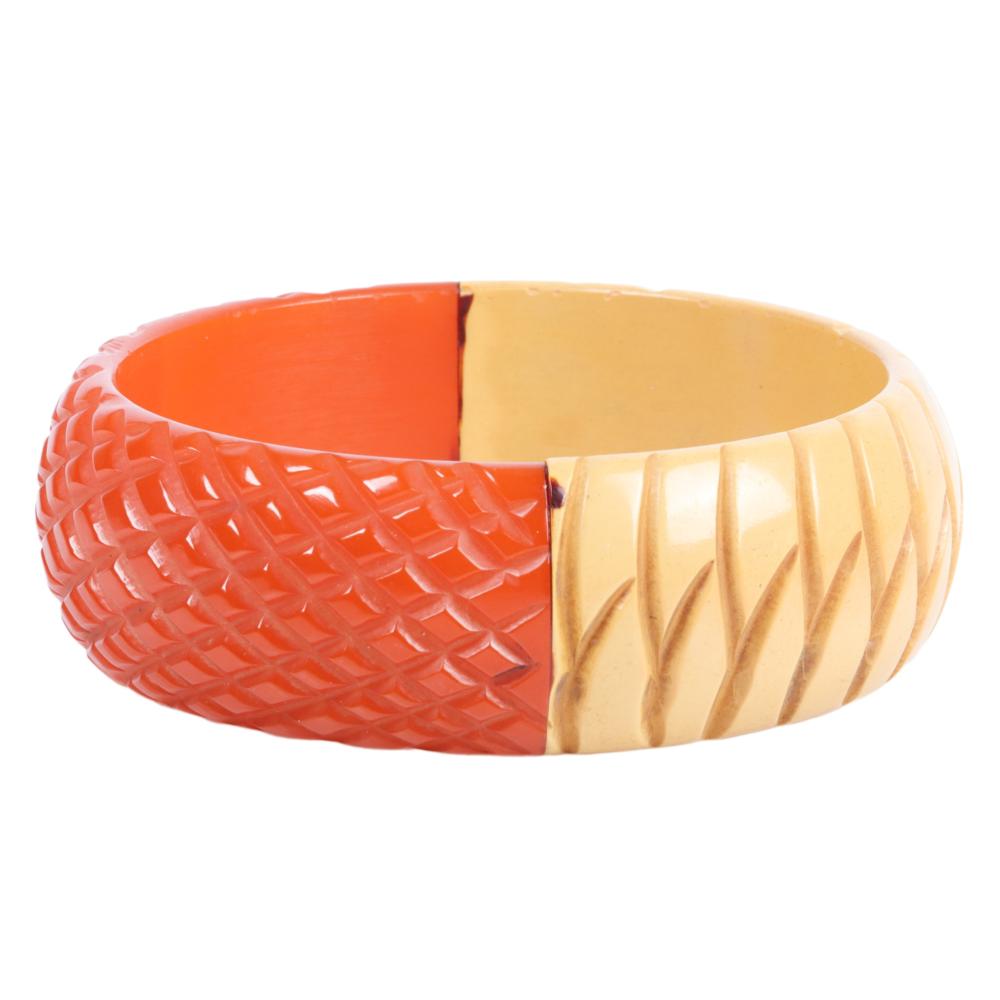 Appraisal: BAKELITE HALF AND HALF DEEPLY CARVED ORANGE AND CREAM BANGLE