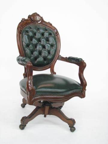 Appraisal: An antique style walnut desk chair with green leather upholstery