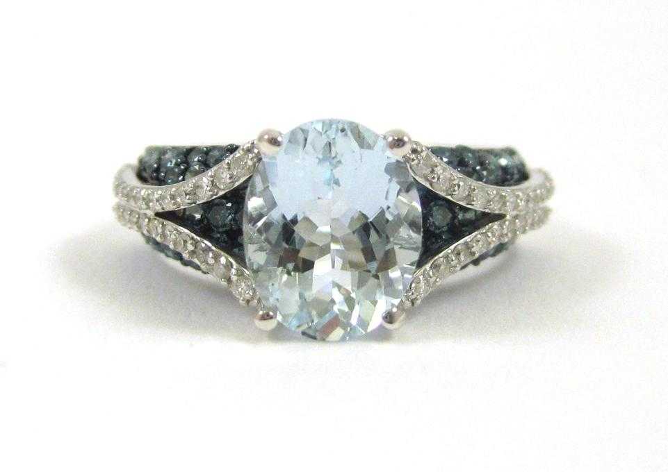 Appraisal: AQUAMARINE AND FOURTEEN KARAT WHITE GOLD RING with round-cut blue