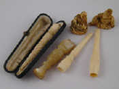 Appraisal: Two ivory netsuke c three cigarette holders one in case