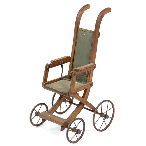 Appraisal: An Edwardian oak folding doll's pushchair on iron wheels with