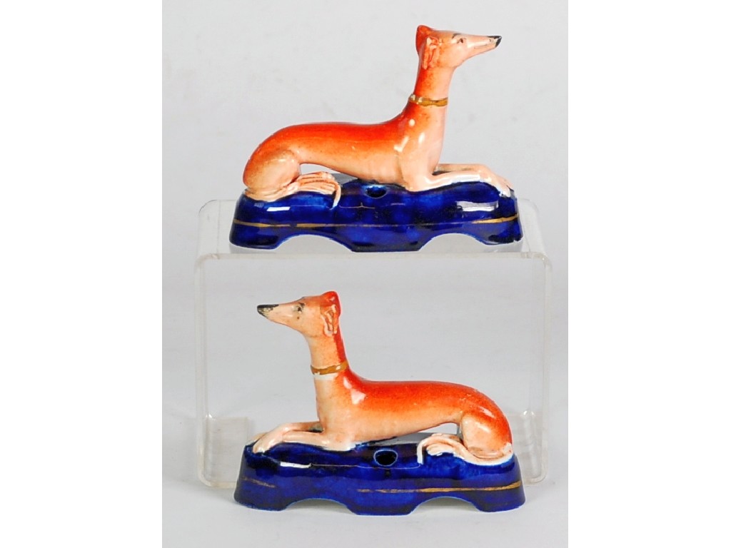 Appraisal: PAIR OF STAFFORDSHIRE RECUMBENT GREYHOUND PORCELAIN INKWELLS typically modelled on