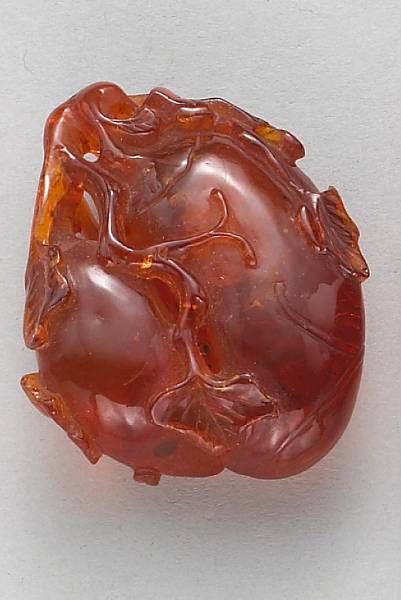 Appraisal: A gourd-shaped amber toggle th Century Of flatttened ovoid and