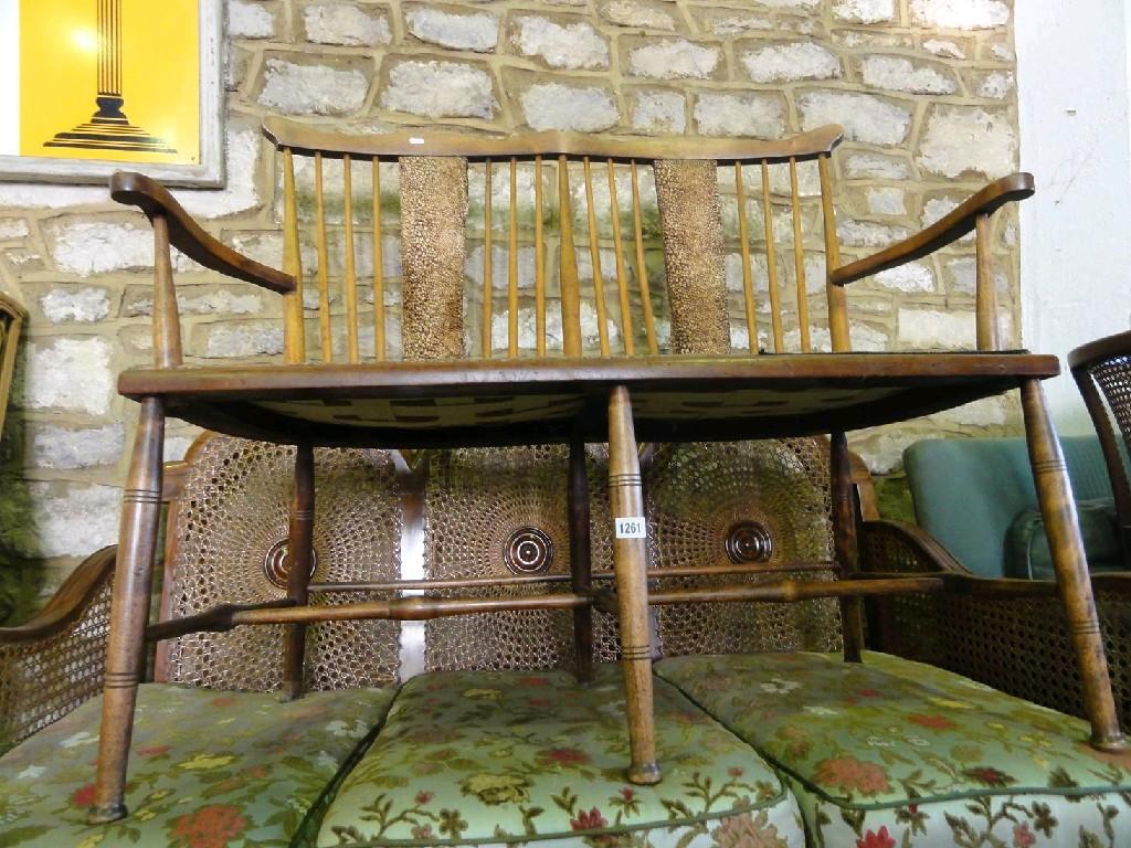 Appraisal: An Edwardian stick back two seat sofa with shaped arms