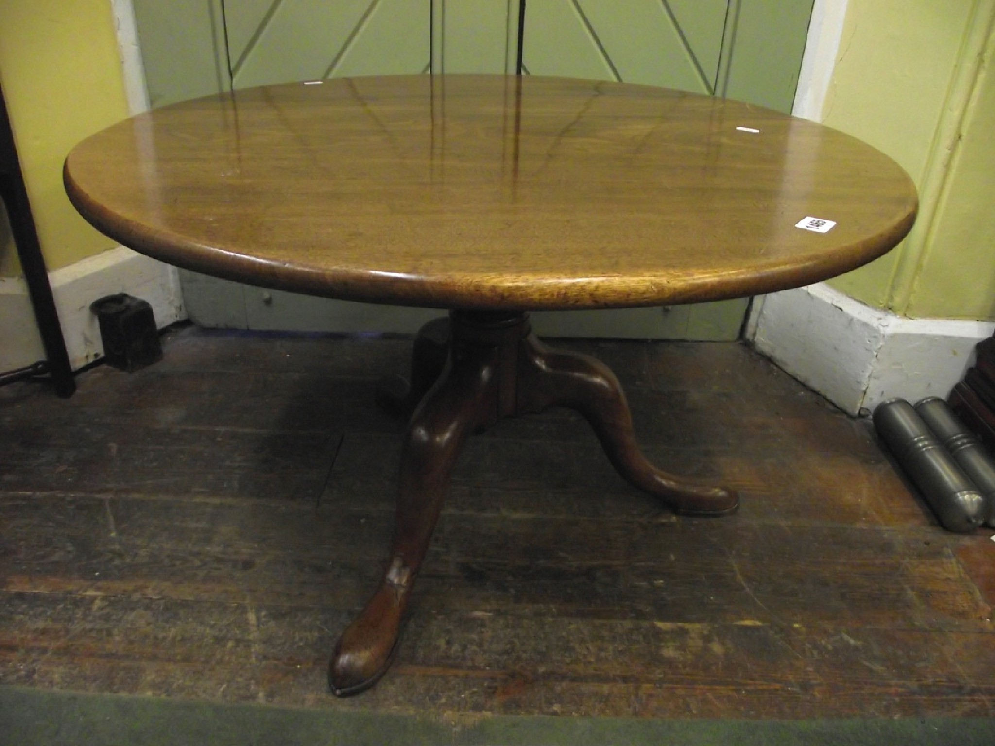 Appraisal: A Georgian mahogany snap top table the single plank top