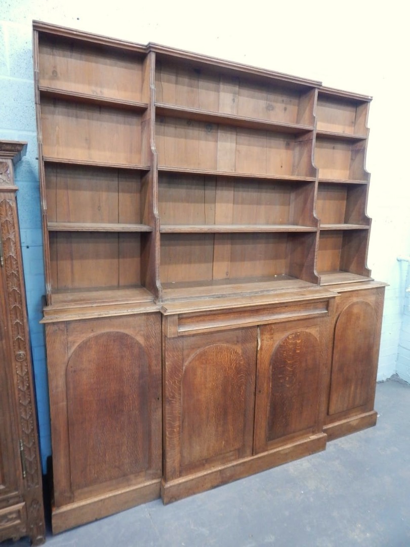 Appraisal: A Victorian oak breakfront bookcase the raised back with a