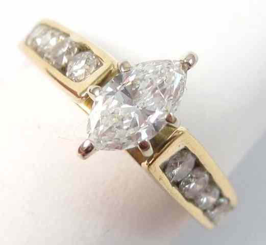 Appraisal: DIAMOND AND EIGHTEEN KARAT GOLD RING centering a marquise-cut diamond