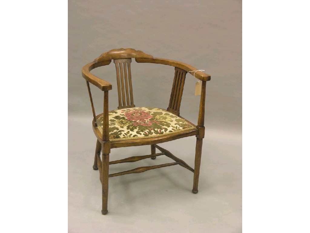 Appraisal: A late Victorian carved walnut salon armchair with upholstered seat