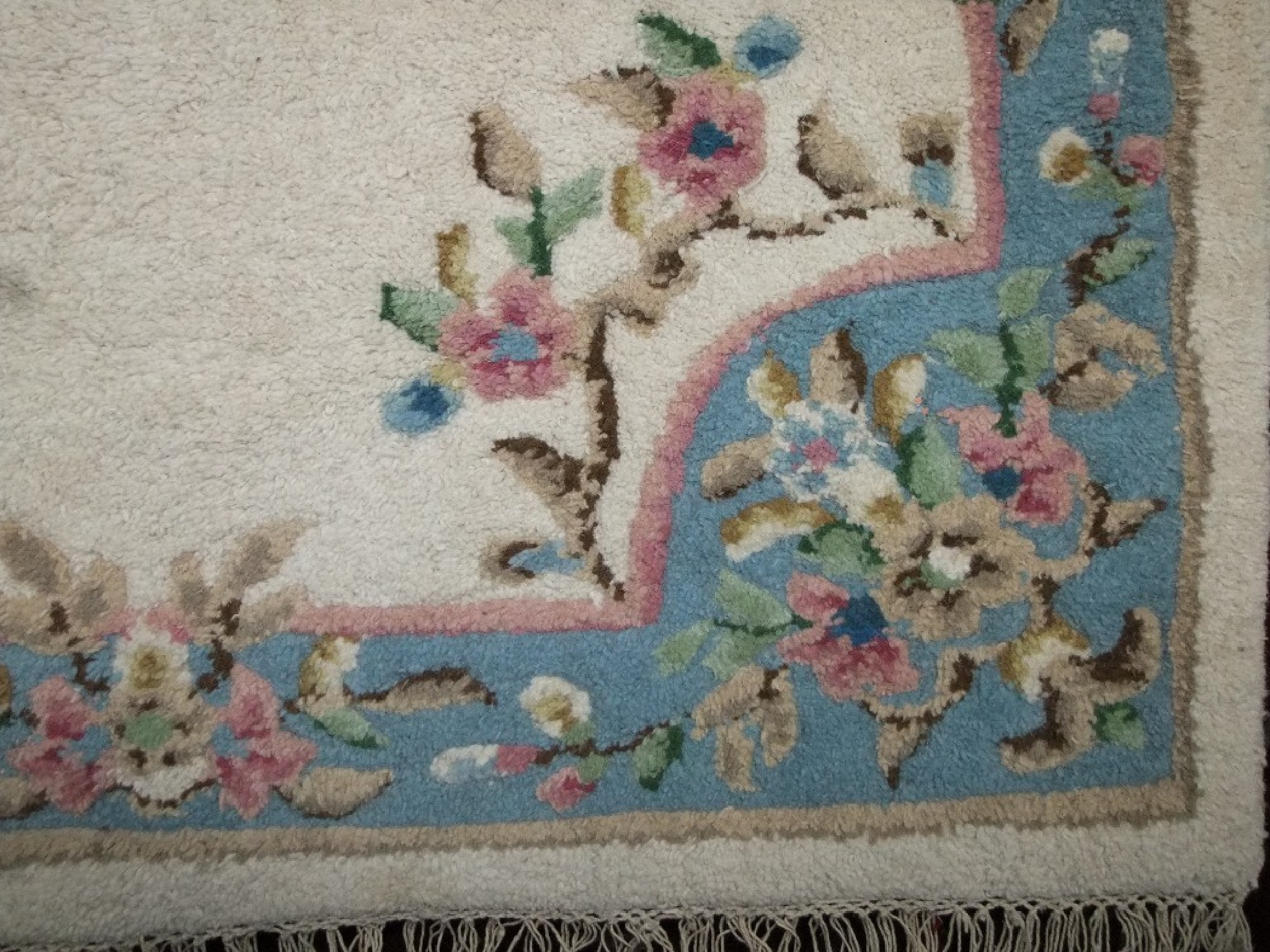 Appraisal: An Indian wool carpet with white ground field within floral