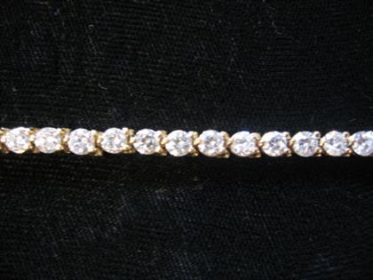 Appraisal: karat yellow gold and diamond tennis bracelet Forty brilliant cut