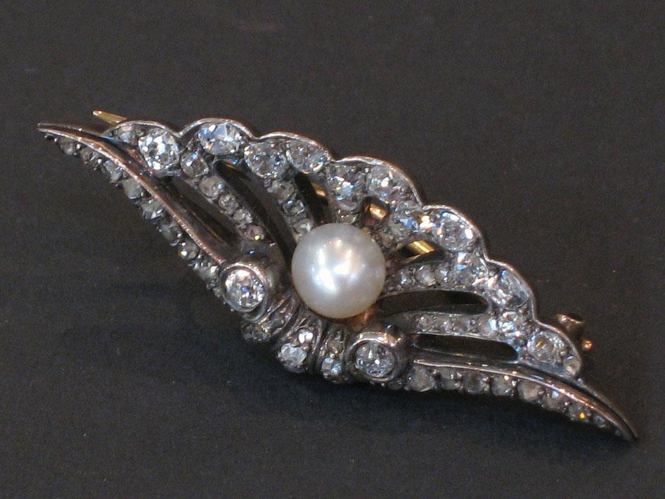 Appraisal: A DIAMOND AND PEARL-SET BROOCH possibly a conversion from a