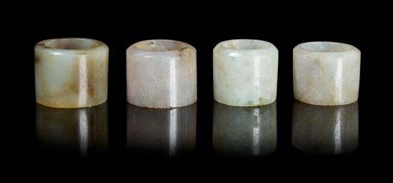 Appraisal: Sale Lot Four Hardstone Archer's Rings comprising a grey and