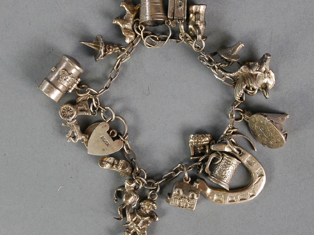 Appraisal: SILVER CHARM BRACELET with padlock clasp and charms